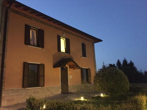 a building with lights in front of it at night at Residence La Canonica in Costa Valle Imagna