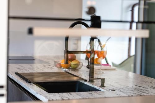a kitchen counter with a sink and a bowl of fruit at Casa Marina in Kulmbach