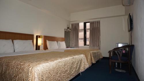 Ein Bett oder Betten in einem Zimmer der Unterkunft Chian Huei Business Hotel