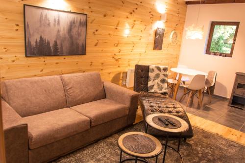 a living room with a couch and a table at Wood Inn in Žabljak