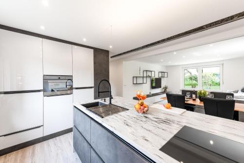 a kitchen with white cabinets and a counter top at Casa Marina in Kulmbach