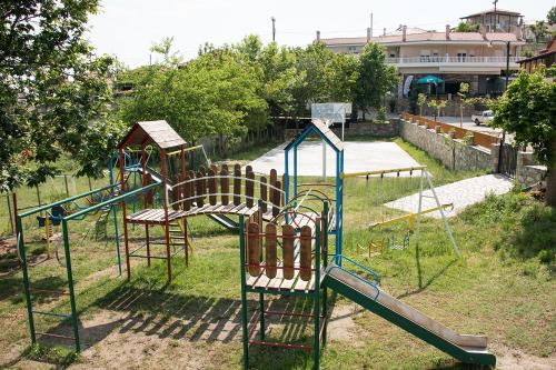 a park with a playground with a slide and swings at Agrelia in Agreliá