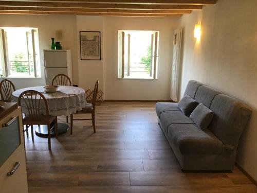 a living room with a couch and a table at Appartamenti Morini in Folgaria