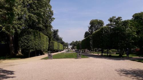 a park with trees and a walkway with statues at Studio avec jardin et stationnement gratuit à Rouen in Rouen