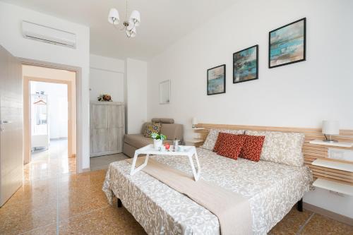 Un dormitorio blanco con una cama y una mesa. en Stars Luxury Apartments 1, en Roma