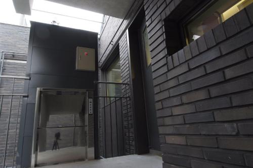 a person walking through a door in a building at DW STAY HONGDAE in Seoul