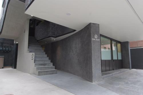 a building with a staircase in front of a building at DW STAY HONGDAE in Seoul