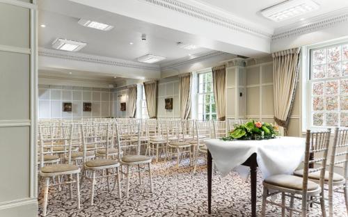 a room with a table and chairs in it at Brandshatch Place Hotel & Spa in Dartford
