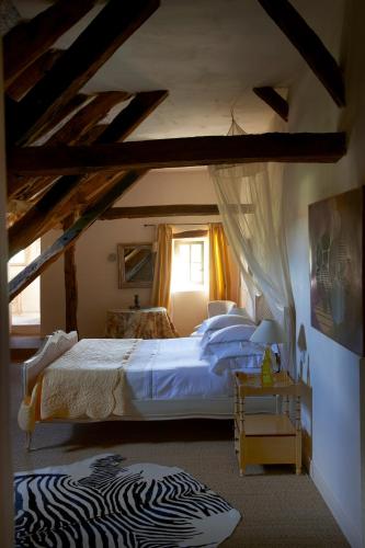 a bedroom with a large bed with a zebraebraebraebraebra at Mas de Garrigue in Calvignac