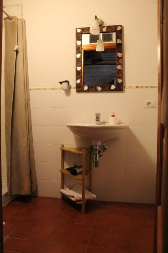 ein Badezimmer mit Waschbecken und Spiegel in der Unterkunft Bassarì in Recanati
