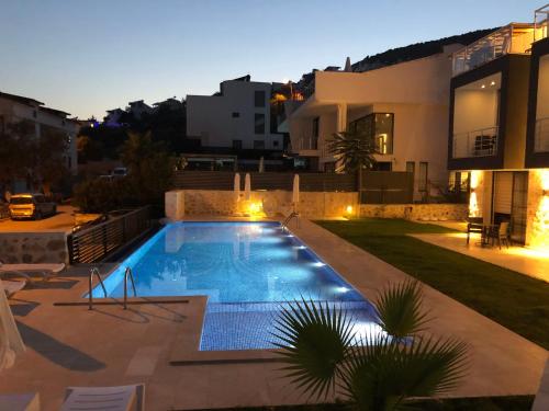 a swimming pool in the backyard of a house at Stonehouse Aparts Dublex 3+1 mit Meerblick und Jakuzzi Kalkan No:5 in Kalkan