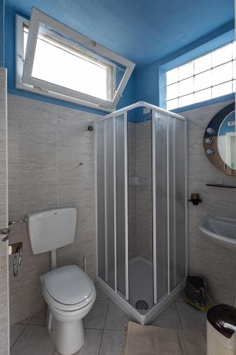 a bathroom with a toilet and a shower and a sink at Ostello di Germagno in Omegna