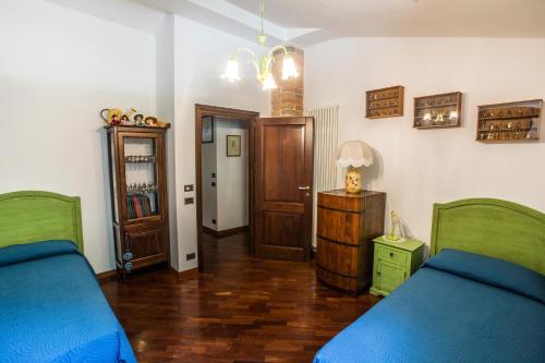 a bedroom with two beds and a door to a hallway at B&B Marconi in Montefalcone Appennino