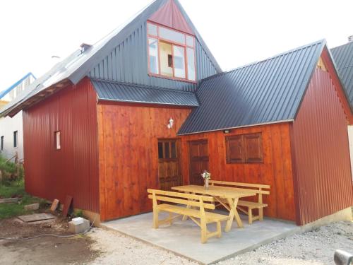 a barn with a picnic table in front of it at Guest House Vukicevic in Žabljak
