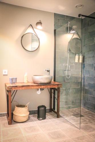 a bathroom with a sink and a glass shower at SOEDER Countryhouse & Kitchen in Båstad