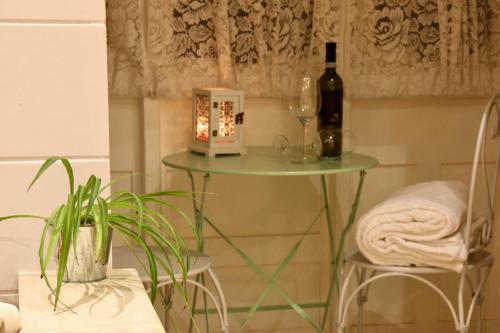a table with a bottle of wine and a glass at Charming Home in Republic street in Valletta