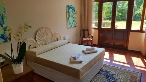 Postel nebo postele na pokoji v ubytování B&B Villa Fiorini