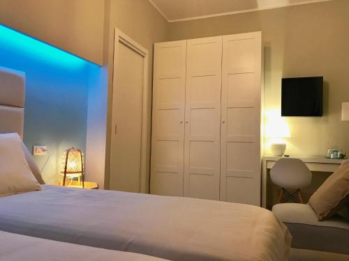 a bedroom with a bed and a desk and a chair at ESMERALDA'S ROOMS in Porto San Paolo