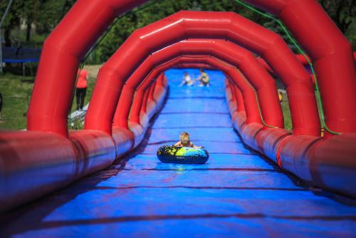 a person in an inner tube on a water slide at Hotel Monínec in Moninec