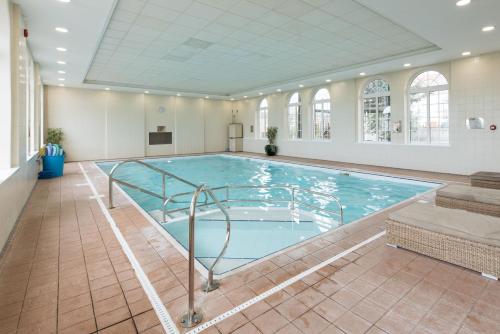 a large swimming pool in a building at The Palace Hotel in Paignton