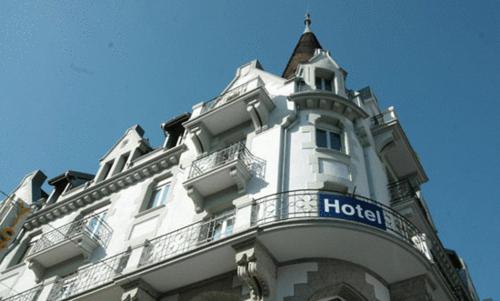 a large white building with a sign on it at Hotel Victoria in Brig