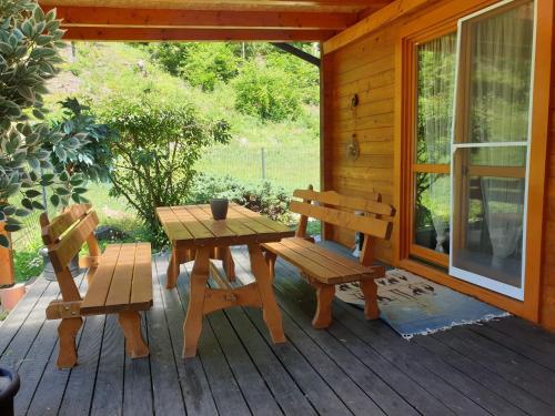 einen Picknicktisch und Stühle auf einer Veranda einer Hütte in der Unterkunft Ferienhaus Familie Hofer in Stockenboi