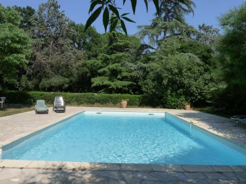 a swimming pool in the backyard of a house at Les Esclots , Nîmes, Gîtes 4 personne in Générac