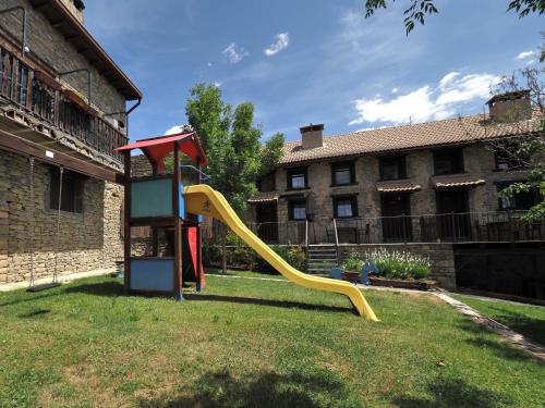 a playground with a slide in a yard at Los Tres Albares in Lardiés