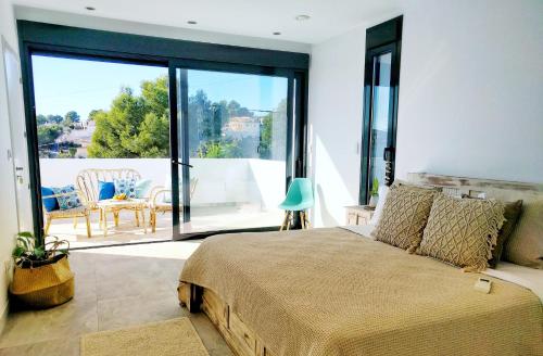 モライラにあるbohospanishvillaのベッドルーム1室(大きなベッド1台、大きな窓付)