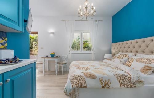 een blauwe en witte slaapkamer met een bed en een raam bij New!!! NEW RIVA LUXURY ONE - with sunny terrace & big garden in Poreč