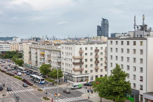 a view of a city with cars and buildings at Sleepy3city Władysława IV 50 in Gdynia