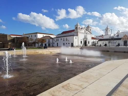 a group of fountains in front of a building at Marreiro's house Algarve - Child friendy - Private Pool in Lagos