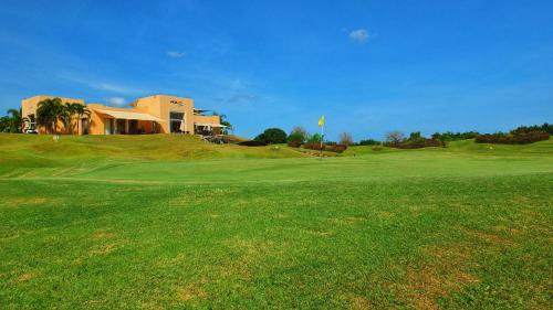 a golf course with a house on top of a green at Vipingo Ridge-Swahili Villa in Mombasa