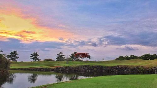 a sunset on a golf course with a lake at Vipingo Ridge-Swahili Villa in Mombasa