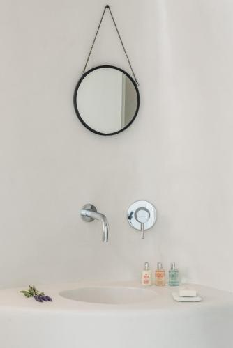 a bathroom sink with a mirror hanging above it at Aspaki by Art Maisons in Oia