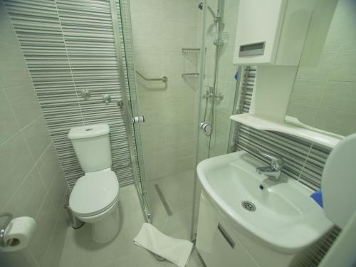 a bathroom with a toilet and a sink and a shower at Hotel Slavija Banja Luka in Banja Luka
