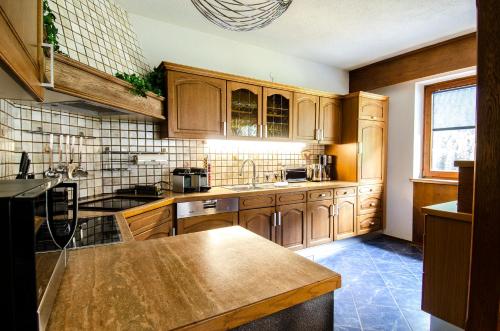 a kitchen with wooden cabinets and a counter top at Ferienhaus Monte Bianco in Kappl