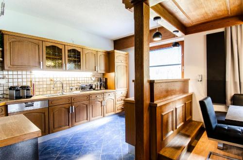 a kitchen with wooden cabinets and a table at Ferienhaus Monte Bianco in Kappl