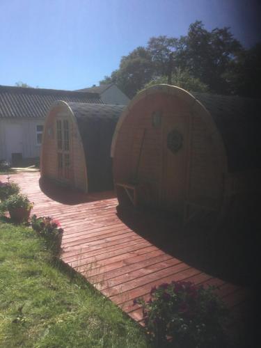 two large wooden barrels sitting on a wooden deck at The Shielings by Inverlochy Villas in Fort William