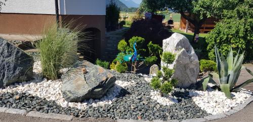 a garden with rocks and plants in a yard at Ferienwohnung Silvia in Sankt Kanzian