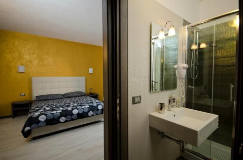 a bathroom with a bed and a sink and a shower at Hotel Rainbow Resort in Marsala