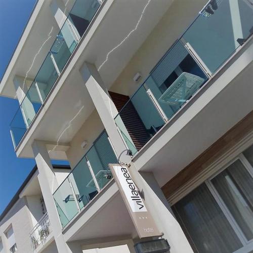 a building with a sign on the front of it at Hotel Villa Enea in Cattolica