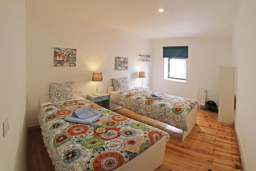 a bedroom with two beds and a window at SweetHome at Alfama's Heart in Lisbon