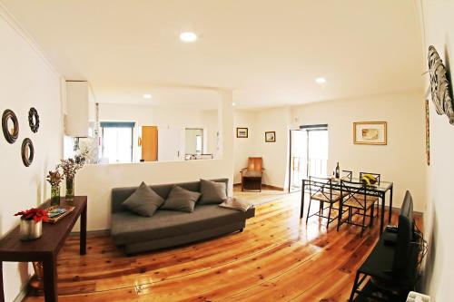 a living room with a couch and a table at SweetHome at Alfama's Heart in Lisbon