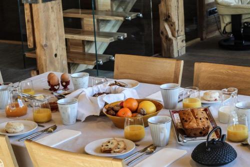 a table with plates of food on top of it at chalet des grands bois in Les Houches
