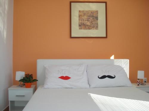 a bedroom with two pillows with moustaches at Apartment Premantura in Premantura
