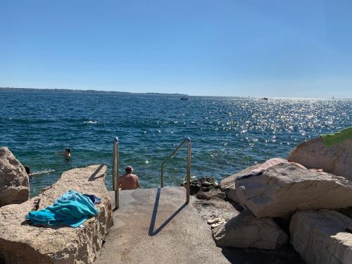 a group of people swimming in the water at Morski Val in Piran