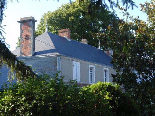 a white house with a chimney and a roof at Château de l'Abbaye - Teritoria in Moreilles