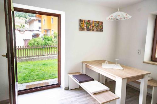 a dining room with a table and a window at Ferienwohnung Eller 79 in Vals