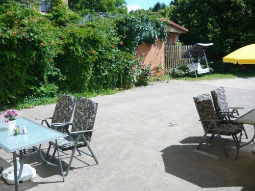 three chairs and a table in a patio at Hotel Krone Lindow in Lindow